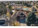 Stunning aerial view of the property showcasing the neighborhood, pool, and tennis court at 2525 22Nd Dr, Longmont, CO 80503