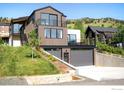 Home exterior featuring an attached garage, manicured lawn, and modern architecture at 2586 3Rd St, Boulder, CO 80304