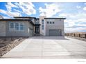 A two-story home displays a modern elevation with a three-car garage at 3564 Doubletrack Ln, Castle Rock, CO 80108