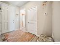 Bright entryway with neutral tones, hardwood floors, and ample closet space for storage at 376 Country Rd, Berthoud, CO 80513