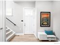 Bright foyer featuring hardwood floors, staircase, and elegant decor at 408 S 2Nd Ave, Superior, CO 80027