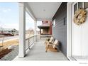 Inviting front porch with stylish wood chairs, perfect for relaxing outdoors at 408 S 2Nd Ave, Superior, CO 80027