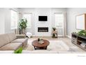 Bright living room featuring a fireplace with a tile surround and large windows allowing plenty of natural light at 408 S 2Nd Ave, Superior, CO 80027