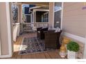 Comfortable outdoor seating area on a covered front porch, perfect for relaxing and enjoying the neighborhood views at 4315 Bella Vista Dr, Longmont, CO 80503