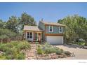 Charming two-story home with a cozy front porch and well-maintained landscaping in daylight at 520 Barberry Ave, Lafayette, CO 80026