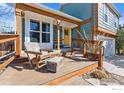 Inviting front porch with seating, a wooden deck, and a view of the home's exterior at 520 Barberry Ave, Lafayette, CO 80026