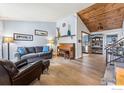 Cozy living room with hardwood floors, vaulted ceilings, and an open layout to the kitchen at 520 Barberry Ave, Lafayette, CO 80026