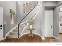 Elegant foyer featuring a curved staircase, hardwood floors, and tasteful decor, setting a welcoming tone at 626 Trails At Coal Creek Dr, Lafayette, CO 80026