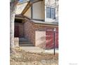 Exterior shot of the home showcasing the brick front, front door, and attached one-car garage at 8239 Kincross Way, Boulder, CO 80301