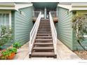 Exterior of a home showcasing a staircase leading to the entrance, architectural details, and outdoor space at 862 S Reed Ct # D, Lakewood, CO 80226