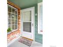 Charming entryway featuring a welcoming door, brick accents, and a glimpse of the cozy interior at 862 S Reed Ct # D, Lakewood, CO 80226