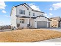 Charming two-story home with white siding, dark trim, and a well-manicured lawn at 1013 Gabriella Ln, Berthoud, CO 80513