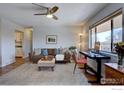 Comfortable living room with hardwood floors and a dedicated workspace by a bright window at 1105 Bacchus Dr # 8, Lafayette, CO 80026