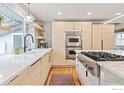 Bright kitchen with light wood cabinets, stainless steel appliances, and a sleek countertop at 1105 Hartford Dr, Boulder, CO 80305