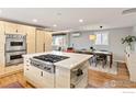 Modern kitchen with stainless steel appliances, island with cooktop and eat-in dining space at 1105 Hartford Dr, Boulder, CO 80305