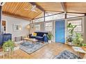 Cozy living room with vaulted ceilings, modern sofa, and a decorative wood burning stove at 1105 Hartford Dr, Boulder, CO 80305