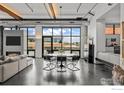 Open-concept living area with modern dining table and industrial-style accents at 1360 Walnut St # Ph 401, Boulder, CO 80302