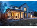 Charming exterior with covered porch and modern design, featuring black framed windows and inviting seating at 1415 Riverside Ave, Boulder, CO 80304