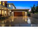 Modern home featuring a stylish wooden garage door with horizontal window accents, and low maintenance xeriscape at 2050 Oak Ave, Boulder, CO 80304