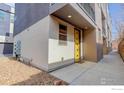 Modern exterior with a yellow front door, showcasing the building's contemporary design at 2051 N Downing St # 5, Denver, CO 80205