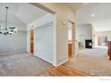 Inviting living room featuring a fireplace, carpet, and hardwood floors at 2443 Winding Dr, Longmont, CO 80504