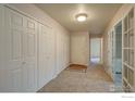 Welcoming entryway with multiple closets and glass doors leading to other rooms at 2604 Elmhurst Cir, Longmont, CO 80503