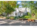 Charming two-story home featuring a welcoming front porch, beautiful garden, and landscaped yard at 3119 9Th St, Boulder, CO 80304