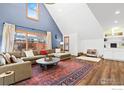 Bright living room featuring a vaulted ceiling, a large sofa, bright windows, and wood floors at 3119 9Th St, Boulder, CO 80304