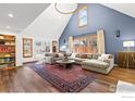 Spacious living room featuring high ceilings, a large sofa, bright windows, and wood floors at 3119 9Th St, Boulder, CO 80304