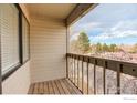 This outdoor balcony offers fresh air and relaxing views with the wooden deck and railing at 3525 28Th St # 304, Boulder, CO 80301