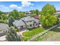 Beautiful property featuring a large backyard, mature trees, and mountain views at 4405 Fairway Ln, Broomfield, CO 80023