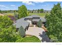 Expansive aerial view of a home with golf course frontage and lush landscaping at 4405 Fairway Ln, Broomfield, CO 80023