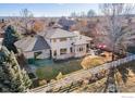 Aerial view of a backyard featuring a white fence, stone patio, and lush landscaping at 4405 Fairway Ln, Broomfield, CO 80023