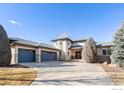 Eye-level home exterior featuring a three-car garage and well-maintained landscaping in the front yard at 4405 Fairway Ln, Broomfield, CO 80023