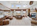 Bright living room featuring large windows, a cozy fireplace, and elegant decor at 4405 Fairway Ln, Broomfield, CO 80023