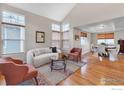 Comfortable living area featuring hardwood floors, multiple windows, and open to the dining space at 4866 Dakota Blvd, Boulder, CO 80304