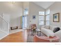 Bright living room featuring vaulted ceiling, large windows, hardwood floors, and stylish contemporary furniture at 4866 Dakota Blvd, Boulder, CO 80304