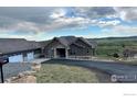 Beautiful single story home boasts stone accents, attached garage, and pristine landscaping at 5489 Country Club Dr, Larkspur, CO 80118