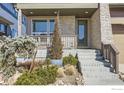 Inviting front porch with stone accents and manicured landscaping at 5626 Four Leaf Dr, Longmont, CO 80503