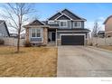 Charming two-story home with stone accents, a two-car garage, and a well-manicured lawn at 5786 Valley Vista Ave, Firestone, CO 80504