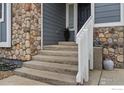 Welcoming front porch with stone accents and charming details at 5786 Valley Vista Ave, Firestone, CO 80504