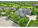Picturesque aerial view of townhomes in a verdant community near a scenic golf course at 588 Beauprez Ave, Lafayette, CO 80026