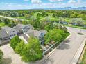 Beautiful aerial view of townhome community with manicured lawns, mature trees, and golf course views at 588 Beauprez Ave, Lafayette, CO 80026