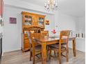 Classic dining room showcasing a wooden dining table, chairs, hutch, and decorative chandelier fixture at 588 Beauprez Ave, Lafayette, CO 80026