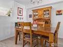 Traditional dining area featuring a wooden table with seating for four, a hutch, and stylish decor at 588 Beauprez Ave, Lafayette, CO 80026
