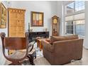 Bright living room with hardwood floors, large windows, and a cozy fireplace, ideal for relaxation and gatherings at 588 Beauprez Ave, Lafayette, CO 80026