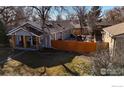 Aerial view of a home with a deck and fenced backyard, perfect for outdoor living and privacy at 6240 W 24Th Ave, Edgewater, CO 80214