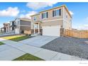 Charming two-story home has a two-car garage, stone accents, and nearby sidewalks at 6536 13Th St, Frederick, CO 80530