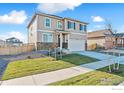 Charming two-story home features a two-car garage, stone accents, and landscaped yard at 6536 13Th St, Frederick, CO 80530