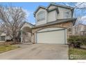 Charming two-story home featuring stone accents and a covered front porch with a two-car garage at 6657 Drew Ranch Ln, Boulder, CO 80301